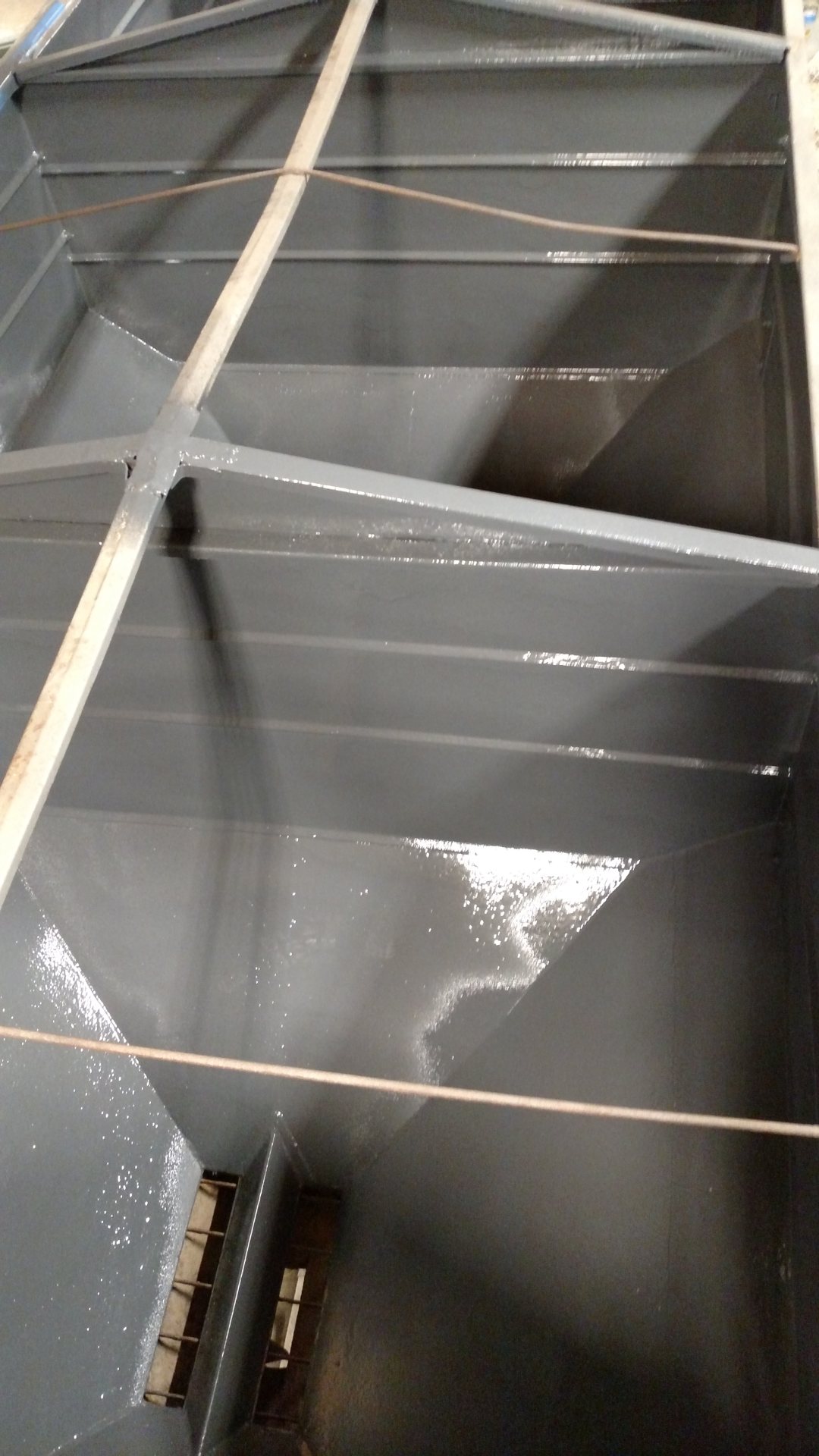 Freshly coated interior of a steel fertilizer hopper