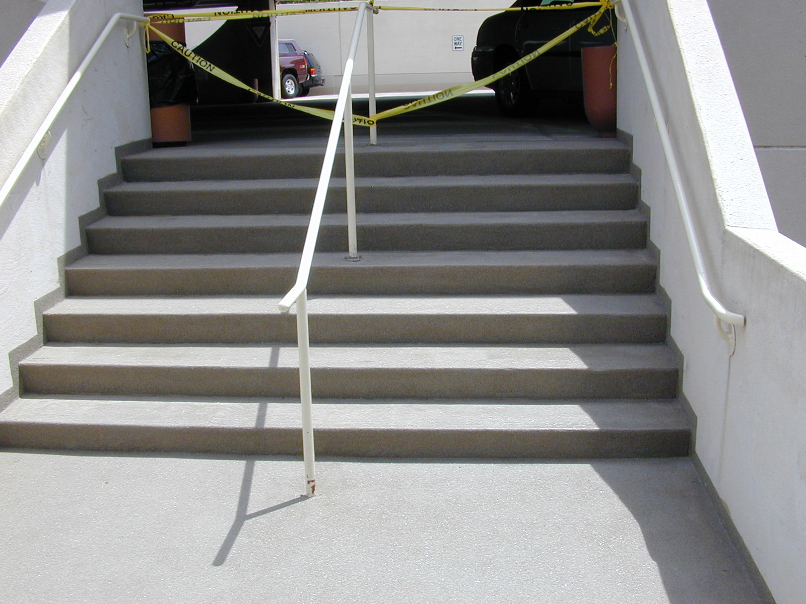 Seamless traffic-bearing coating over concrete stairs and landing at a parking structure