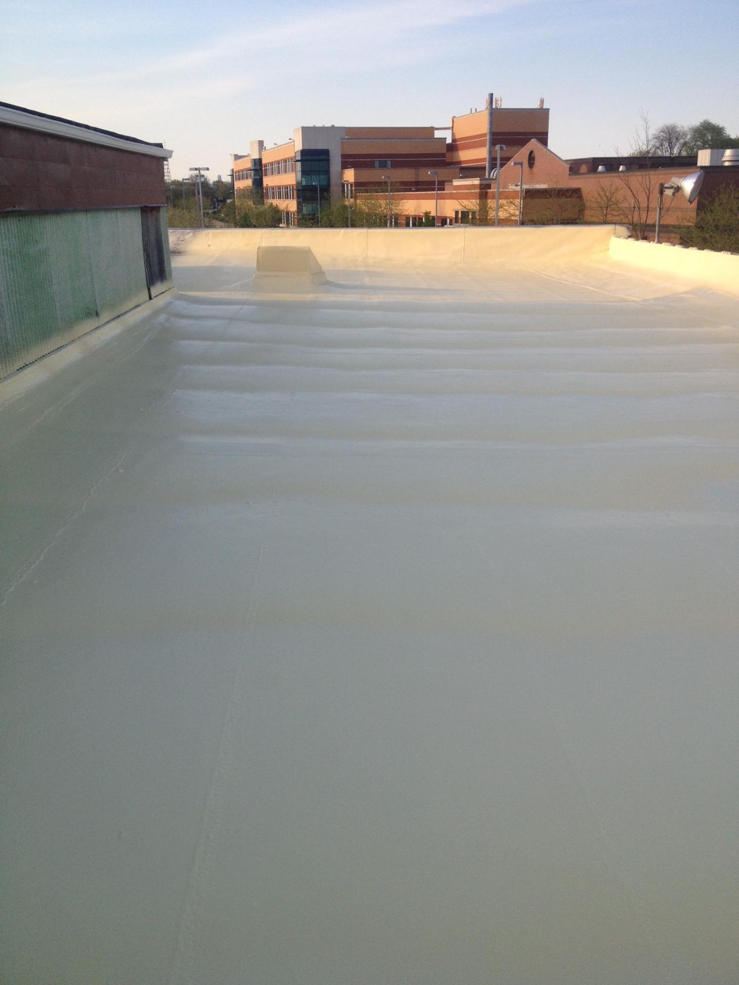 Spray foam and polyurea coating applied to rooftop — seamless foam and coating roof system
