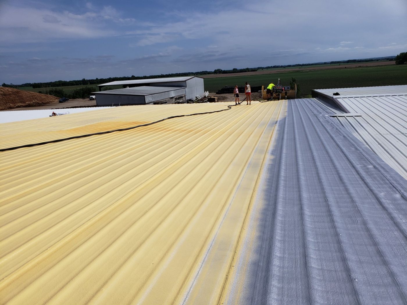 Metal roof restoration in progress, with coated and uncoated sections side by side