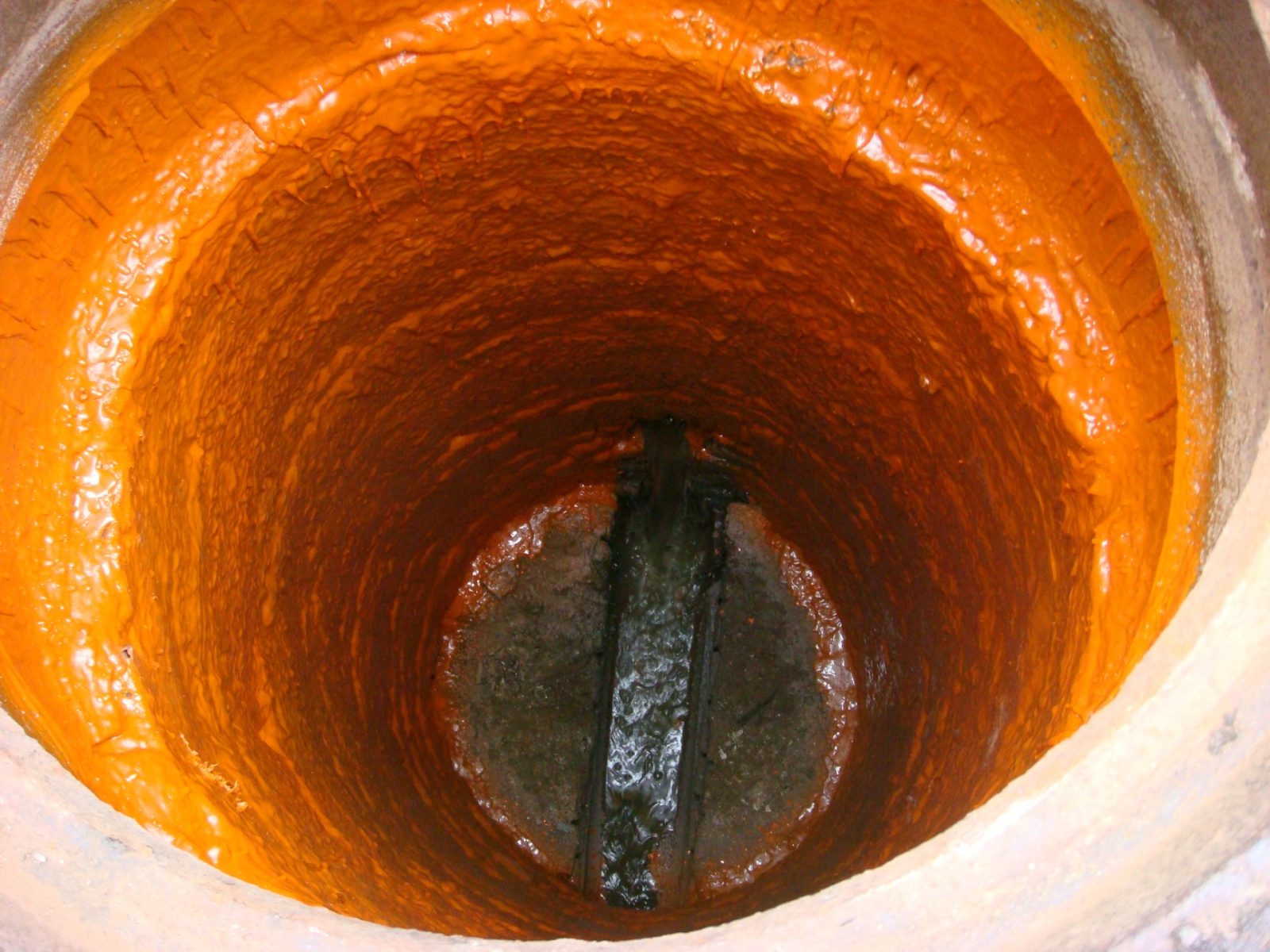 Polyurea lining sprayed inside a concrete manhole to seal the underground structure