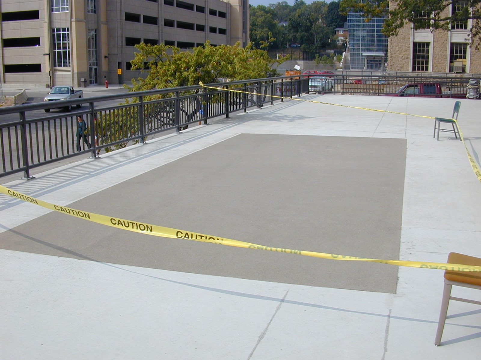 Waterproof traffic-bearing coating on a plaza deck with the parking structure behind