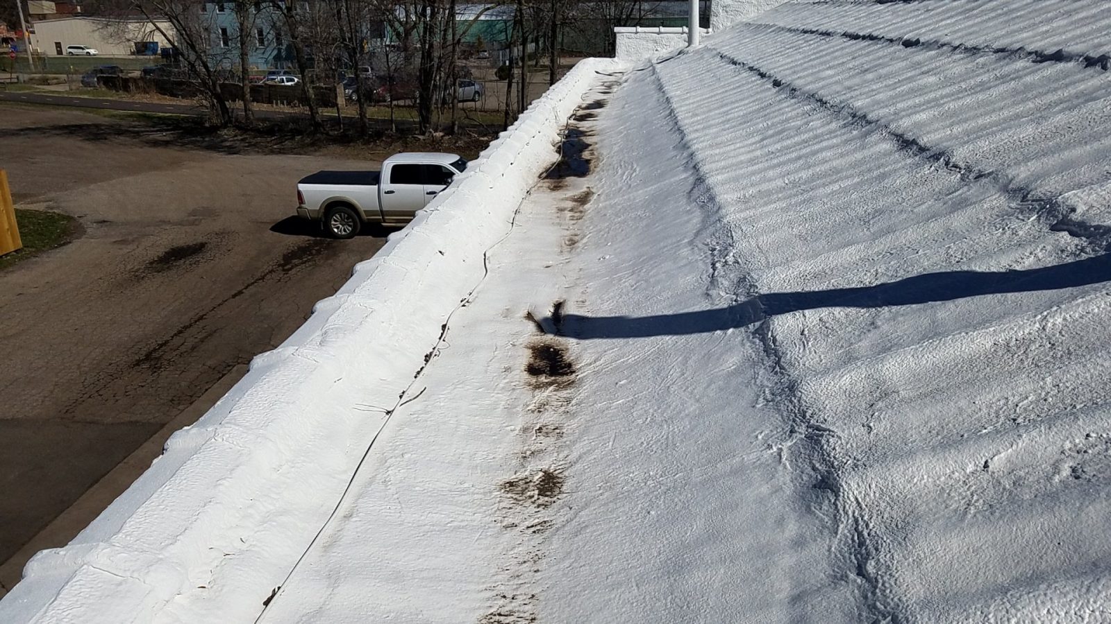 Closed-cell spray foam roof with an elastomeric topcoat, renewed without tear-off