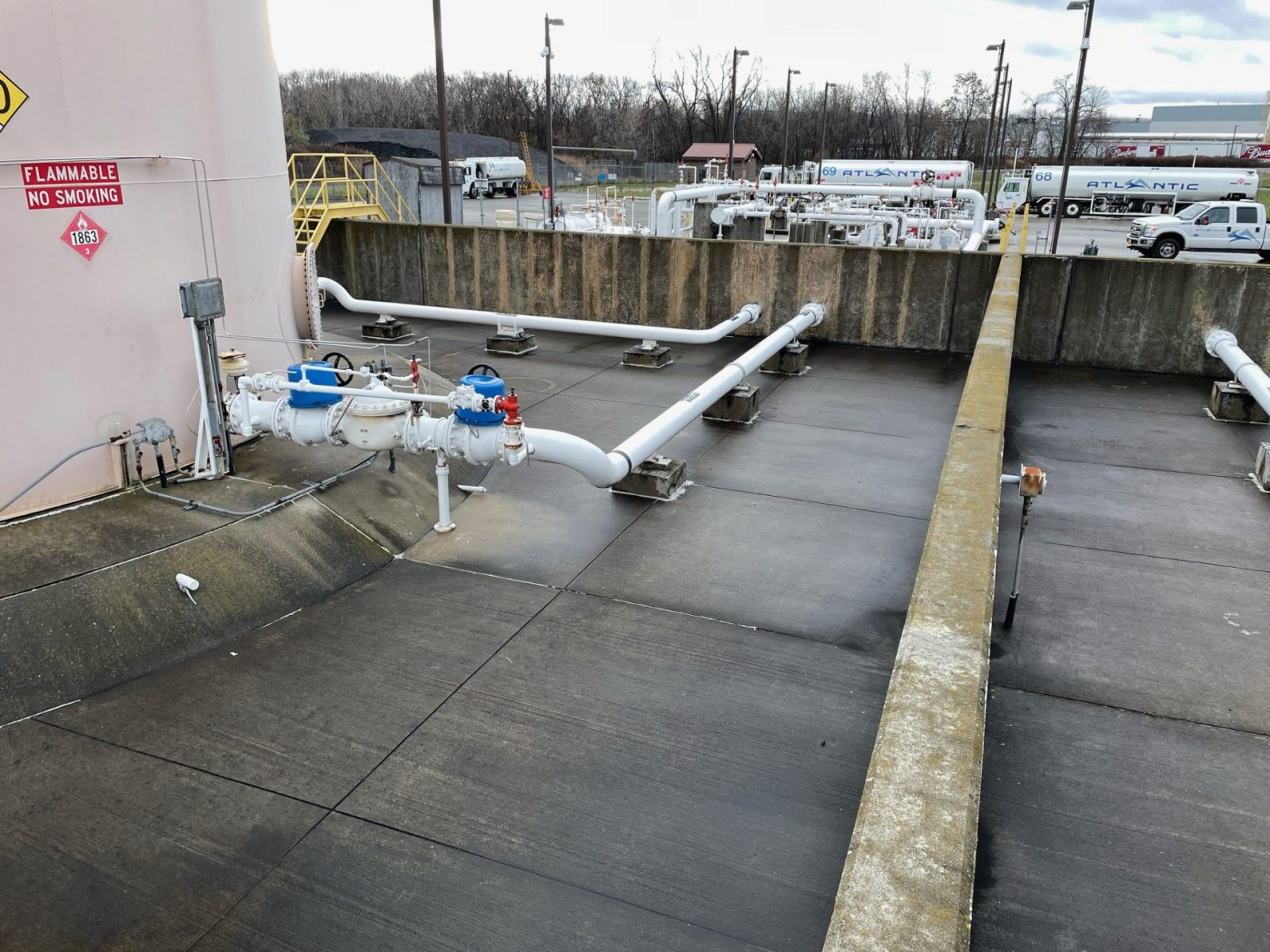 Polyurea-lined secondary containment floor and dike walls around a bulk fuel tank farm