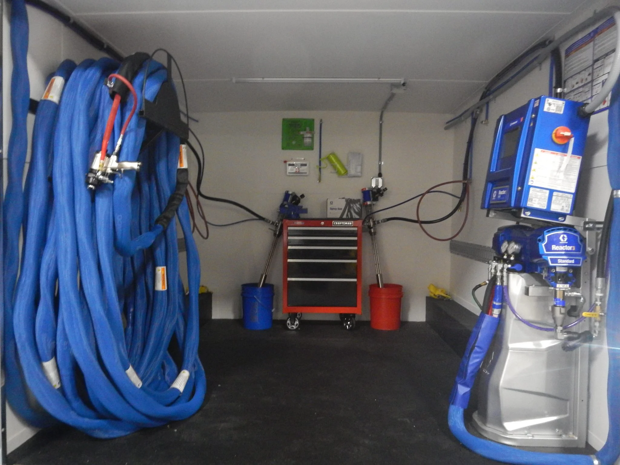 a blue hoses and a machine in a garage