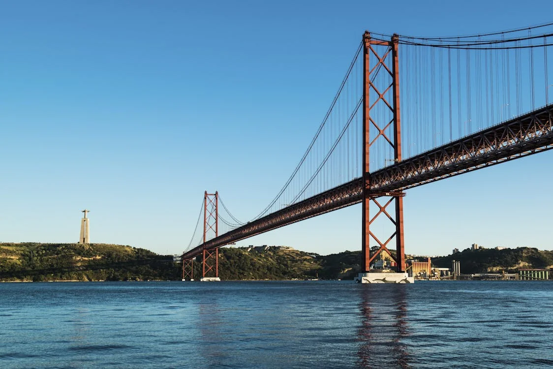 a large red bridge over water