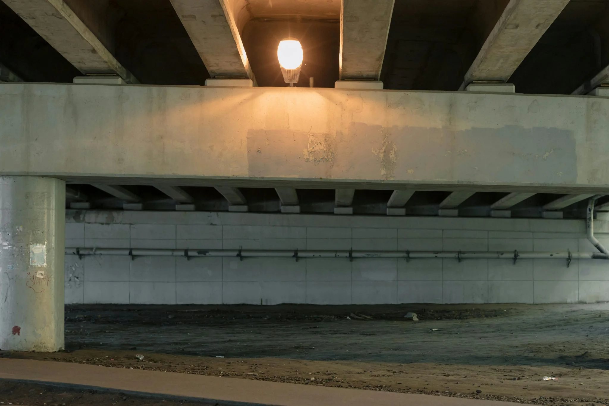 a light on a light above a concrete bridge