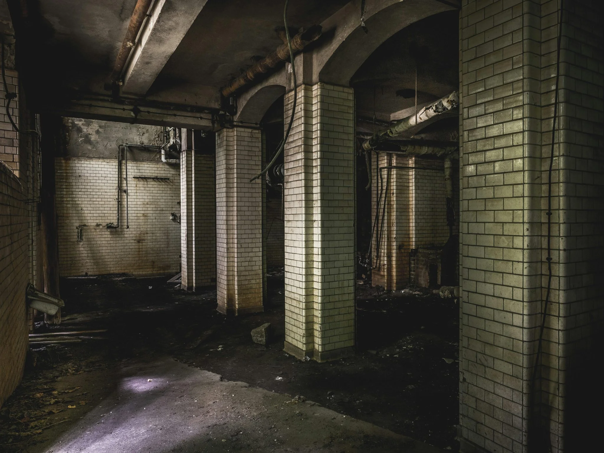 a room with brick pillars and a dirty floor