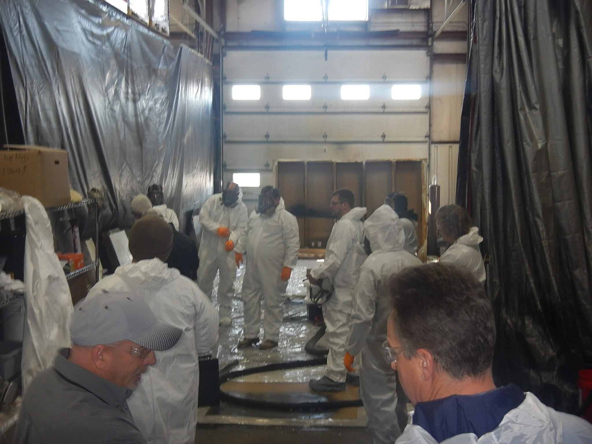 a group of people in white protective suits