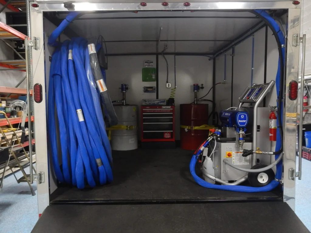 a truck with blue hoses and a red box