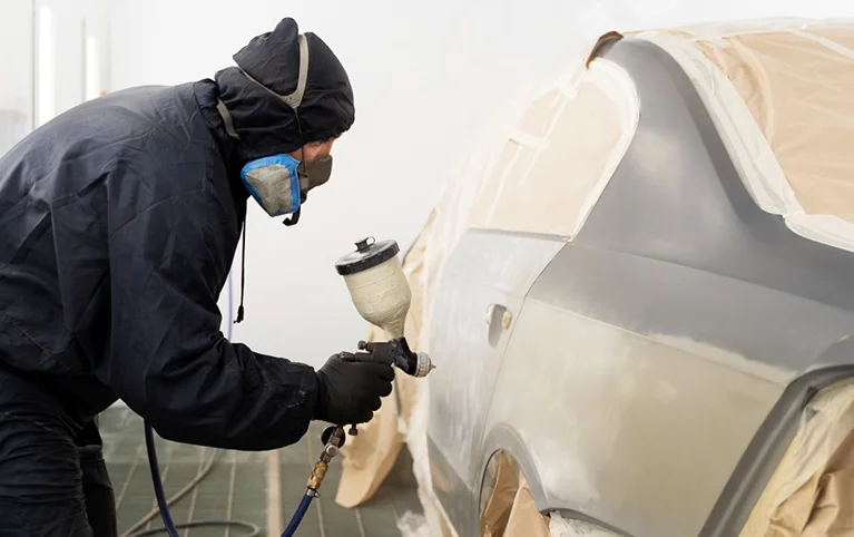 a man painting a car