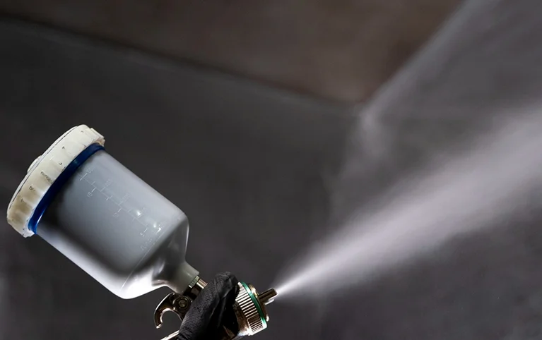 a person spraying a spray gun