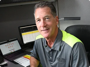 a man sitting at a desk with a laptop
