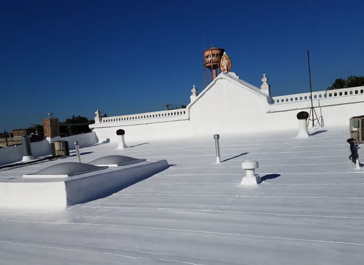 a white building with a water tower on top