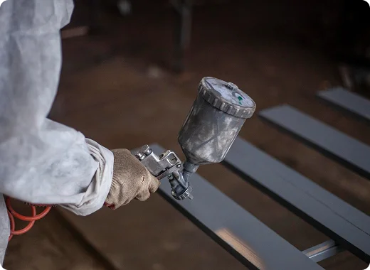 a person holding a spray gun
