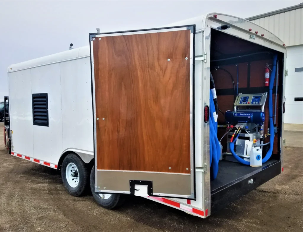 a white trailer with a wood door